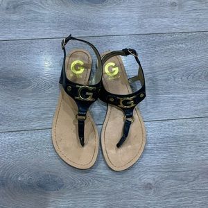 G By Guess Black and Gold Gladiator Sandals